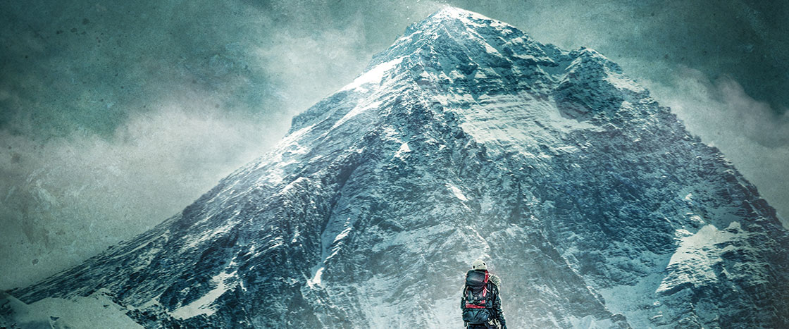 a climber in front of a large mountain