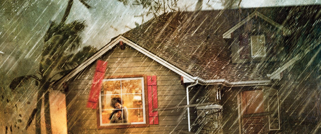 Illustration of a woman hugging her child inside their home as a storm surges outside