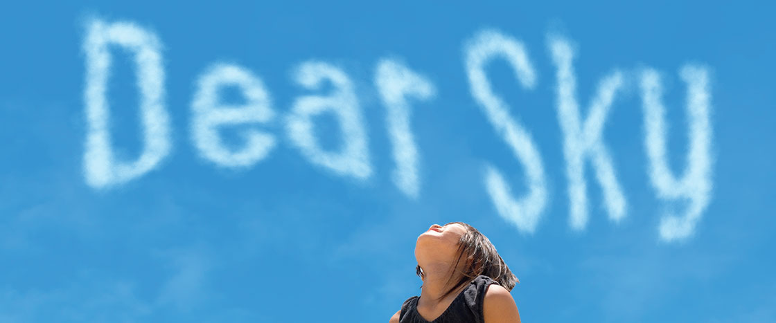 A child looking up at the sky and the text "Dear Sky"