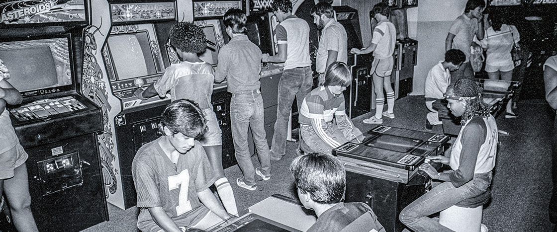 Black & white photo of teens at an arcade