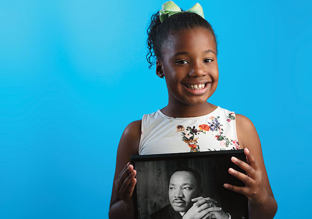 A Picture of Dr. king being held by his granddaughter