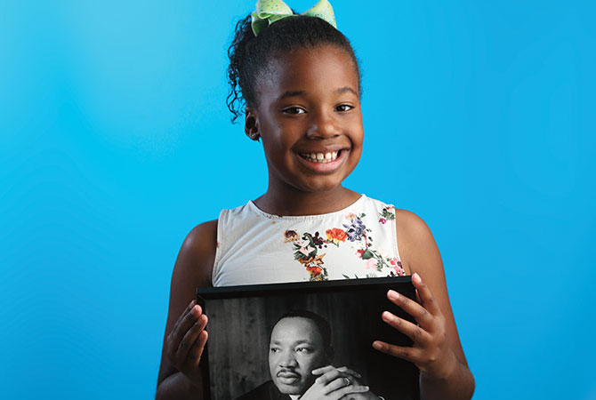 A Picture of Dr. king being held by his granddaughter